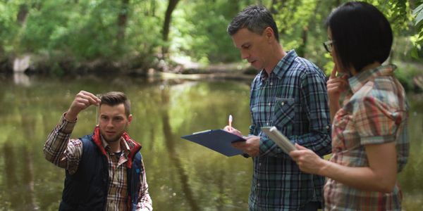 Field team conducting a groundwater study in a stream.